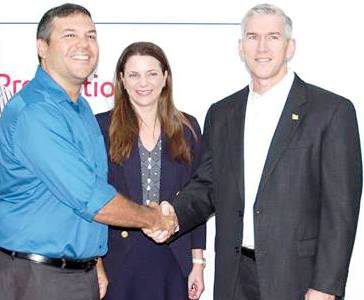 Philip Fernandes (left) with ExxonMobil’s Country Manager, Rod Henson (right) and its public relations executive Kimberley Brasington.
