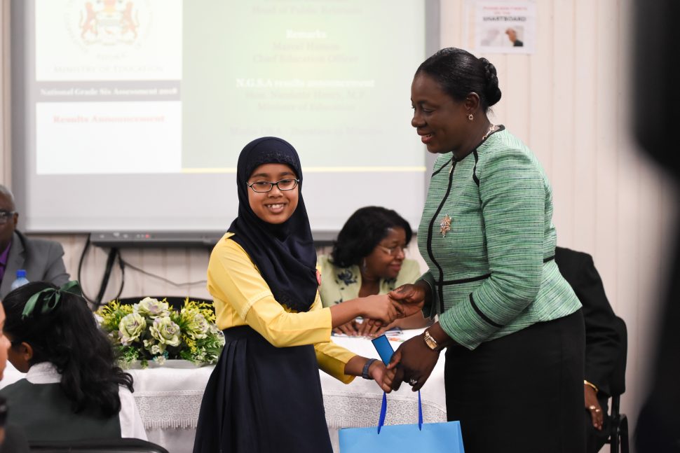 Top student, Naila Rahaman being congratulated yesterday by Minister of Education Nicolette Henry. (Department of Public Information photo)