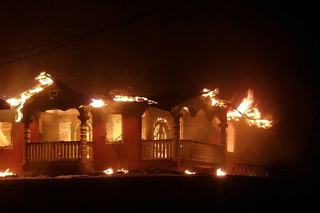 The house engulfed by flames on Friday evening.