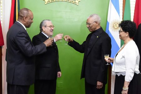 President David Granger (second from right) shares a toast with new Argentinean ambassador, Felipe Alejandro Gardella.  At left is Minister of State Joseph Harmon. At right is Audrey Waddell of the Foreign Ministry. (Ministry of the Presidency photo)
