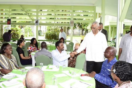 President David Granger (standing second from right) greeting a guest at the Baridi Benab. Standing at right is GPSU President, Patrick Yarde. (Ministry of the Presidency photo)
