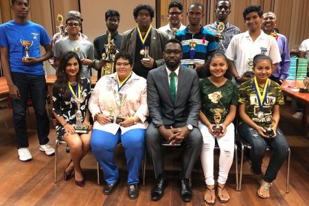 A group photo of the recipients of prizes for the 2018 men, women and junior national chess championships. Director of Sport Christopher Jones officiated at a prize-giving ceremony that was held at the Racquet Centre on Friday, March 25. Jones (sitting) is flanked by, from left: Yolander Persaud, attorney; Maria Varona-Thomas, businesswoman and Nellisha and Waveney Johnson, students. Standing are the other prize winners.
 
