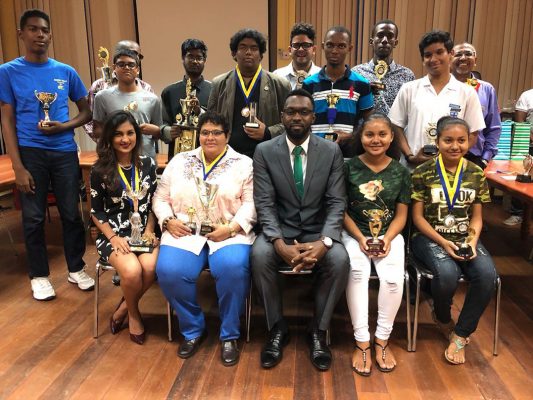 A group photo of the recipients of prizes for the 2018 men, women and junior national chess championships. Director of Sport Christopher Jones officiated at a prize-giving ceremony that was held at the Racquet Centre on Friday, March 25. Jones (sitting) is flanked by, from left: Yolander Persaud, attorney; Maria Varona-Thomas, businesswoman and Nellisha and Waveney Johnson, students. Standing are the other prize winners.
 
