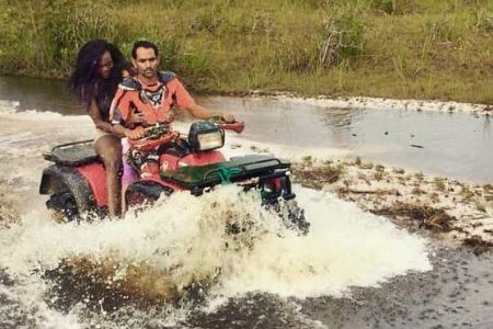  A couple powers through a flooded section of the trail on an ATV during the drive last year. 