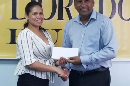 El Dorado brand Manager, Maria Munroe (left) presents Lusignan Golf Club President Aleem Hussain with the sponsorship cheque in the boardroom of DSL Ruimveldt yesterday.
