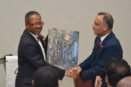 Professor Al-Zubaidy (right) receiving a painting from the UG Vice Chancellor, Ivelaw Griffith.(DPI photo)