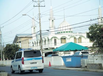 A police vehicle drives past the Masjid-ul-Muttaqeen Mosque on Munroe Road, Cunupia. The mosque has shot into the limelight after workers found a cache of guns and ammunition in the roof of the women’s toilet on Thursday.