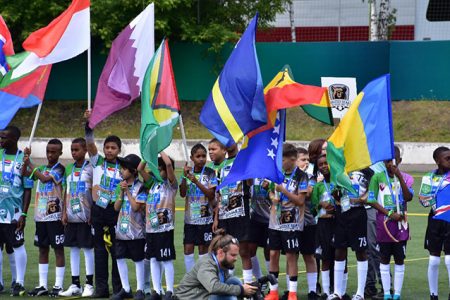 Guyana’s representative and flag bearer Jalade Trim (seventh from left) and Josiah King (eighth from left) during the opening ceremony of the Gazprom International Social Children’s Program, ‘Football for Friendship, at the Spartak Football Academy, Moscow, Russia on Saturday.
