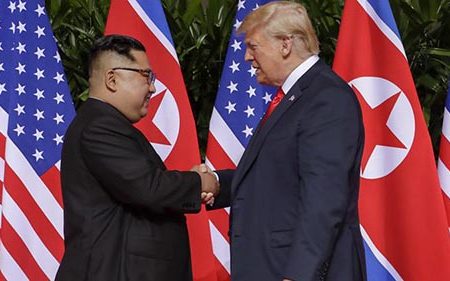 U.S. President Donald Trump shakes hands with North Korea’s leader Kim Jong Un before their bilateral meeting at the Capella Hotel on Sentosa island in Singapore June 12, 2018. REUTERS/Jonathan Ernst