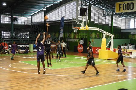 Action between LTI (purple) and GTI in the National School Basketball Festival (NSBF) at the Cliff Anderson Sports Hall, Homestretch Avenue.