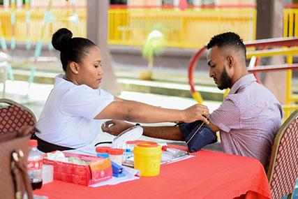 Occupational Therapist, Calvin Lawrie, who spearheaded the blood drive preparing to give blood. (DPI photo)