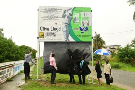  Roger Harper (right) and Mayor Patricia Chase-Greene (left) unveils the Clive Lloyd Drive sign.