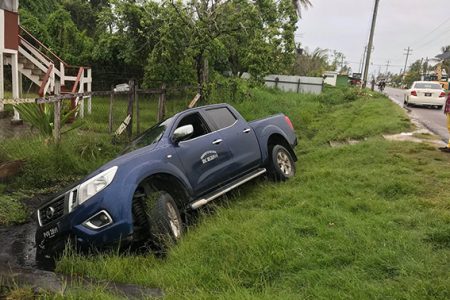 Defensive swerve: This open back pickup slid off the road at Buxton on the Railway embankment on Saturday afternoon after it swerved from a vehicle that was travelling in its path, the driver said. The driver of the vehicle told Stabroek News that a car heading east on the northern carriageway was travelling at a fast rate and was in his lane on the opposite side of the road.  He said there was nothing he could have done and he swerved over into the opposite lane and skidded off the road.  No one was injured.