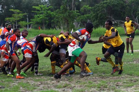 Rugby action involving the Pepsi Hornets and the Yamaha Caribs yesterday at the National Park. The blue, white and red clad Hornets earned a victory over their arch rivals. (Orlando Charles photo)