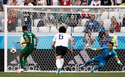 Saudi Arabia’s Salman Al-Faraj scores their first goal from the penalty spot past Egypt’s Essam El-Hadary REUTERS/Damir Sagolj