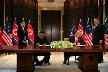 U.S. President Donald Trump and North Korea's leader Kim Jong Un sign documents that acknowledge the progress of the talks and pledge to keep momentum going, after their summit at the Capella Hotel on Sentosa island in Singapore June 12, 2018. REUTERS/Jonathan Ernst