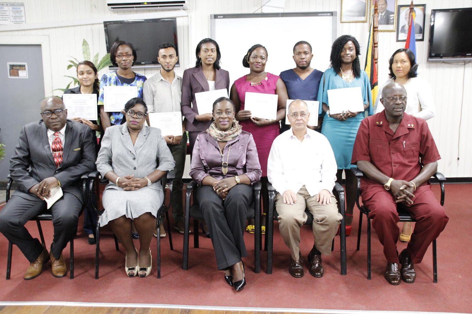 Seated from right are: Permanent Secretary within the Ministry of Education,  Vibert Welch; Cuban Ambassador to Guyana,  Narciso R. A. Socorro; Minister of Education,  Nicolette Henry; Permanent Secretary within the Ministry of Public Health, Colette Adams and Chief Education Officer,  Marcel Hutson.  Standing from right are  Yolanda Williams, June Herod,  Keenan Benjamin, Michelle Nicholas,  Kalina Phillips,  Calvin Lawrie,  Mycinth Robertson and  Kelly Coonjah. 