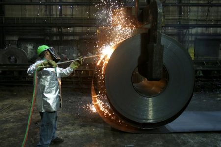 A worker cuts a piece from a steel coil at the Novolipetsk Steel PAO steel mill in Farrell, Pennsylvania, U.S., March 9, 2018.  REUTERS/Aaron Josefczyk/File Photo