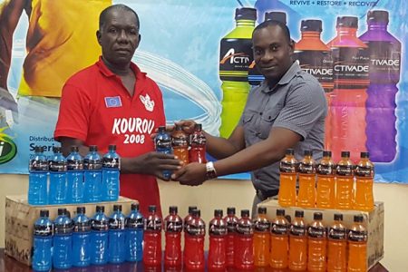 Sueria Manufacturing Inc. Brand Manager Selwyn Bobb (right) hands over some of the Activade Energy Drinks to GCF Assistant Racing Secretary, Joseph Britton.  
