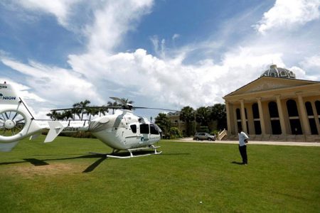 A man stands near a Union Development Group helicopter in front of an old casino at Dara Sakor hotel at Botum Sakor in Koh Kong province, Cambodia, May 6, 2018. Picture taken May 6, 2018. REUTERS/Samrang Pring