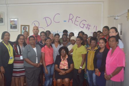 Participants and facilitators pose for a group picture as Regional Chairman, Genevieve Allen is seated at the opening of the Capacity Building Workshop on Gender being held at RDC Region Four Triumph, East Coast Demerara. (Region Four photo)