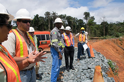 Minister Raphael Trotman observes operation at a mining pit at Karouni  (DPI photo)