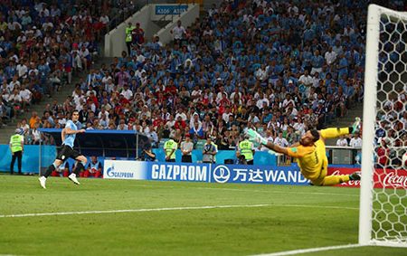 GAME WINNER! Uruguay’s Edison Cavani places a right-footer past the diving Portugal goalkeeper Rui Patricio  and into the net. (Reuters photo)