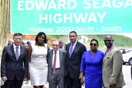 Prime Minister Andrew Holness (third right), after the unveiling of the sign renaming the North-South Highway the Edward Seaga Highway.  Edward Seaga is fourth from right.
