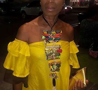 Trinidadian designer Sandra DeFreitas in one of Akilah’s designer pieces while sporting her own handmade African necklace
