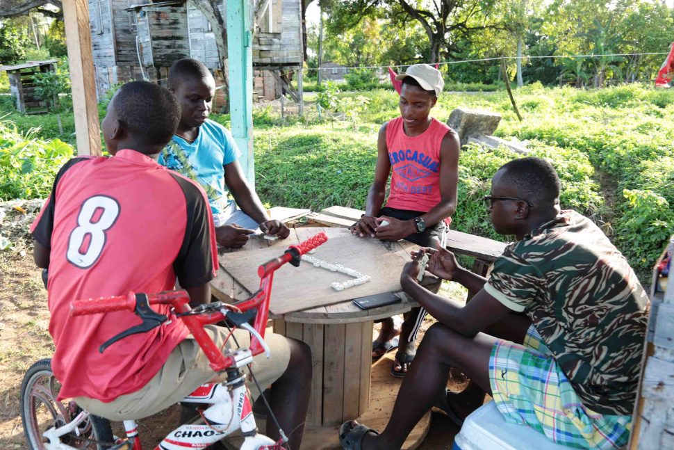 These young men enjoy a game of dominoes