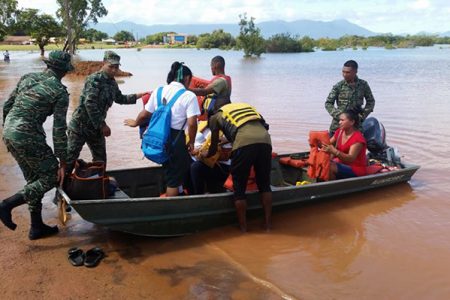 Members of the Guyana Defence Force assisting flood-affected residents in Lethem and surrounding areas. The army has been working with the region by providing a boat shuttle service for residents from 6 am to 6 pm daily. (GDF Photo) 