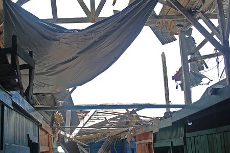 Several zinc sheets resting on vendors’ stalls after falling from the roof.
