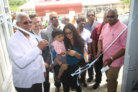 Minister of Agriculture Noel Holder (at left) along with other officials helps to cut the ribbon on the newly-commissioned Enmore drainage pump station. (Terrence Thompson photo)