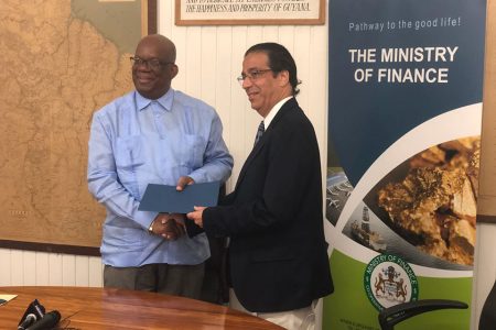 Minister of Finance Winston Jordan (at left) along with World Bank Senior Country Officer Pierre Nadji after the signing of the agreement yesterday.  