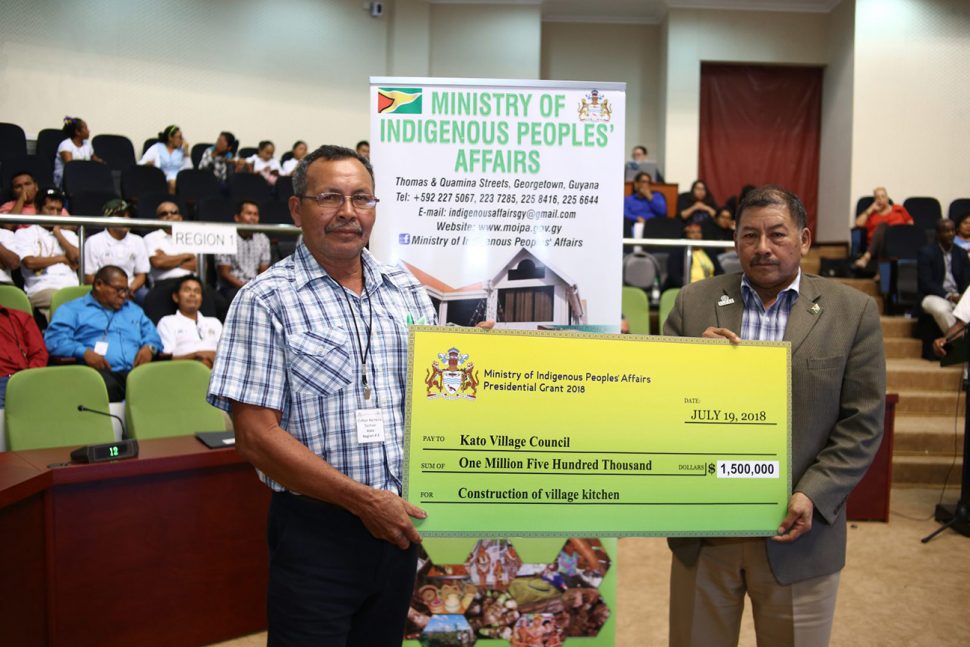 Toshao of Kato Village Clifton Perreira receiving a presidential grant from Minister of Indigenous Peoples’ Affairs Sydney Allicock on Friday, when the National Toshaos Council annual conference concluded at the Arthur Chung Conference Centre. (Department of Public Information photo)
