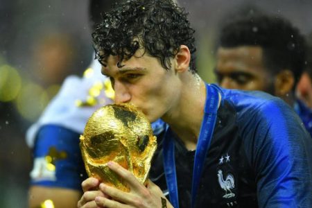 France’s Benjamin Pavard kisses the FIFA trophy as he celebrates winning the World Cup (REUTERS/Dylan Martinez)