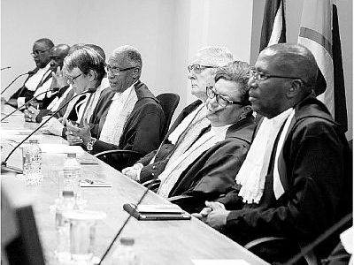 Newly-appointed President of the Caribbean Court of Justice, Adrian Saunders, fourth from right, addresses Saturday’s special sitting of the court in commemoration of his appointment at the CCJ’s headquarters on Henry Street, Port-of-Spain. At Right is Chief Justice Ivor Archie. PICTURE COURTESY THE CCJ