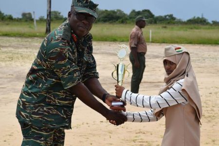 Alliah Shaw receiving her prize for ‘Best Camper’ from Chief of Staff of the GDF, Brigadier Patrick West. (DPI photo)
