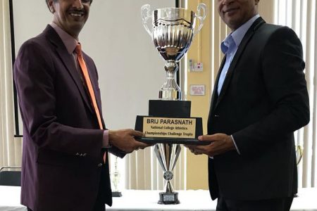 Guyanese-born International Sports Commentator/Analyst, Brij Parasnath (left) and Aubrey Hutson, President of the Athletics Association of Guyana display the Brij Parasnath Challenge Trophy which will be rewarded to the winning team today.
