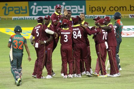 The West Indies team celebrates its last gasp win over Bangladesh in the second day/night one dayer last night at the Providence National Stadium.(Orlando Charles photo)