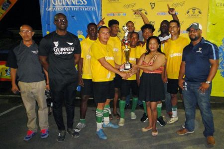 Disconnection Crew captain Ryan Andries (left) collecting the winner’s trophy from Banks DIH Limited Bartica Branch Manager Brenda Murray, following the conclusion of the finale. Also in the photo is Guinness Brand Manager Lee Baptiste (2nd from left)