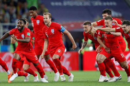 The England players celebrate their victory over Colombia.

