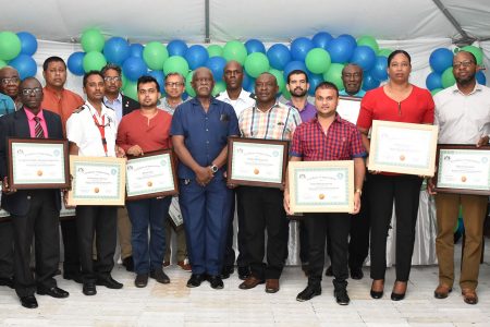 Minister of Citizenship, Winston Felix (centre) with some of those who were recognized. (Ministry of the Presidency photo)
