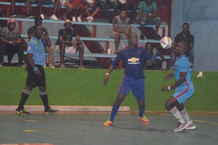 Jermaine Samuels (left) of Silver Bullets and Selwyn Williams of Back Circle tussling for possession of the ball during their round of 16 clash at the National Gymnasium in the GT-Beer ‘Keep Ya Five Alive’ Futsal Championships.