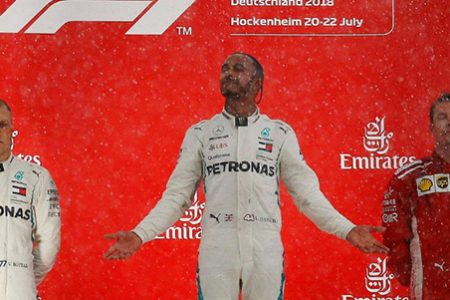 Mercedes’ Lewis Hamilton celebrates on the podium after winning the race alongside second placed Valteri Bottas of Mercedes and third placed Kimi Raikkonen of Ferrari REUTERS/Wolfgang Rattay