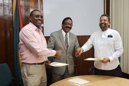 Chairman of the LCA, Courtney Wynter (left) and UCC Executive Chancellor and Interim President Professor Dennis Gayle (right) shaking hands with Attorney General Basil Williams shortly after the agreement for the establishment of a law school in Guyana was signed (Photo courtesy of the Ministry of Legal Affairs and Attorney General’s Chambers)