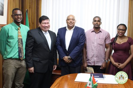 Minister of Natural Resources, Raphael Trotman (centre) with Ambassador of Mexico to Guyana, Ivan Roberto Sierra Medel (second from left) and the three scholarship awardees. (MNR photo)