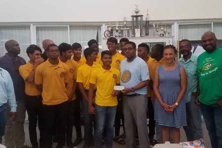 Queen’s College alumnus, Dr. Terrence Blackman (third from right in front row) handing over a cheque for US$5,000 to the School’s cricket team Captain Amos Sarwan. The money which was donated will be used for the rehablitation of the school’s field. Some members of the alumni started a project one year ago to get the school’s field cleared. According to QC alumnus Alfred Granger, the initiative started with the clearing of one acre of the nine-acre field. For the year so far members of the alumni have donated over $7M to the school for various projects.