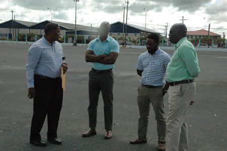 Guinness Brand Manager Lee Baptiste (2nd ;left), Outdoor Events Manager Mortimer Stewart (left) and other Banks DIH officials made a site inspection yesterday, at the National Stadium.