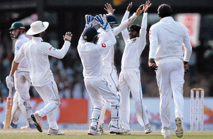 Sri Lanka’s Akila Dananjaya (C) celebrates with his teammates after taking the wicket of South Africa’s Keshav Maharaj (not pictured). REUTERS/Dinuka Liyanawatte.